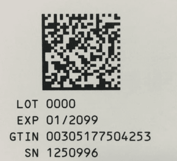 Close-up photo of a printed GS1 DataMatrix code with human-readable serial number, expiry date, and lot number on a pharmaceutical carton label.